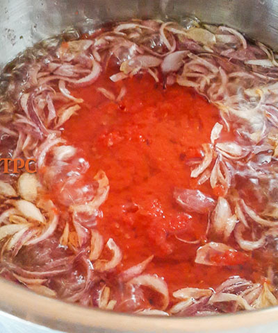 sliced onions and tomato just beginning to fry for nigerian tomato stew base