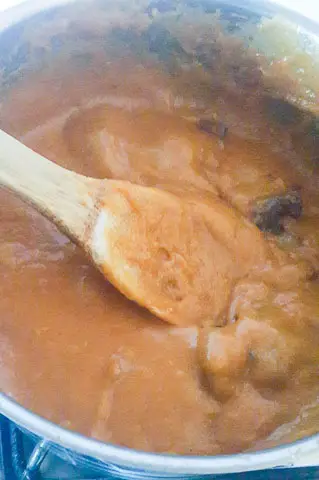 agidi jollof cooking in a pot