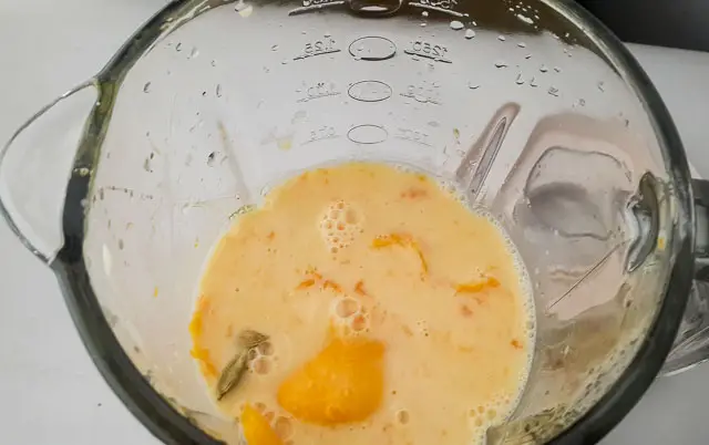 mango lassi ingredients in a blender