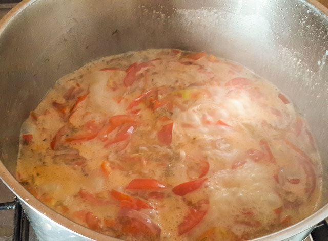 tomato, onions and pepper in coconut milk for Nigerian Coconut Rice