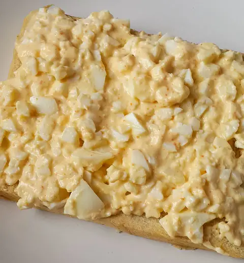 mashed egg and mayonnaise on slice of bread for boiled egg sandwich