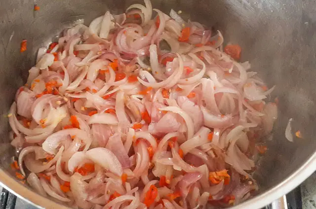 onions and peppers frying for Nigerian Coconut Rice