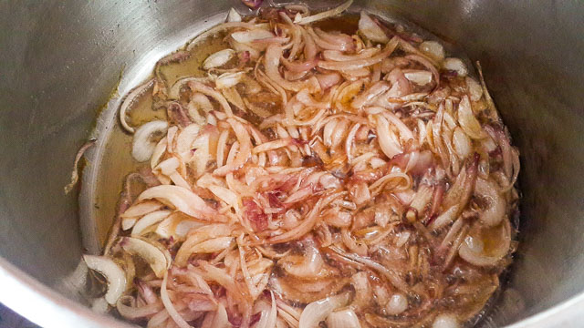 onions frying Nigerian palm oil jollof rice