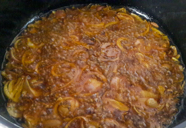 sliiced onions frying in bleached palm oil stew