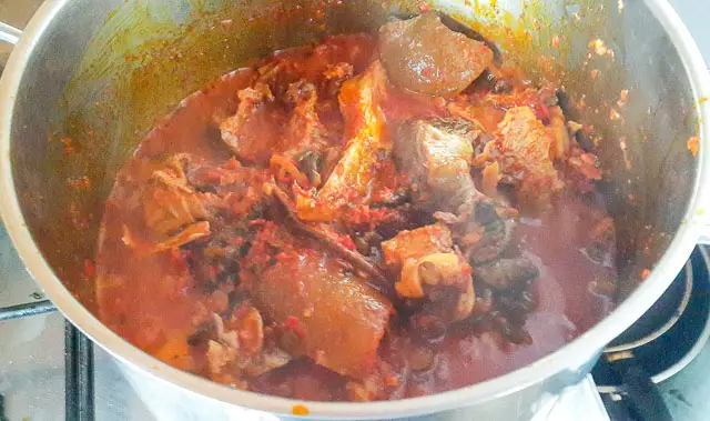 stew and meat in a pot for Efo riro (vegetable soup)