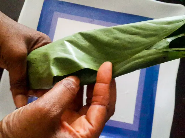 ukpo ogede, nigerian plantain pudding wrapped in uma or banana leaves
