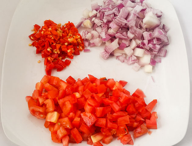 vegetables prepped for High heat is necessary so that the tomato won't leach out too much water and end up dry and broken down. Freshness is desireable.