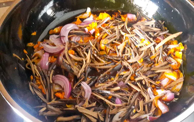 sauteing onions for achicha, dry cocoyam