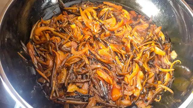 onions etc frying in palm oil for achicha, dry cocoyam