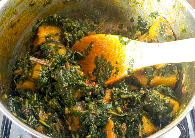 vegetable yam being stirred in a pot