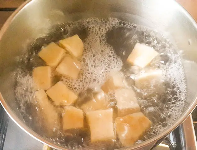 yam cubes boiling in a pot for vegetable yam