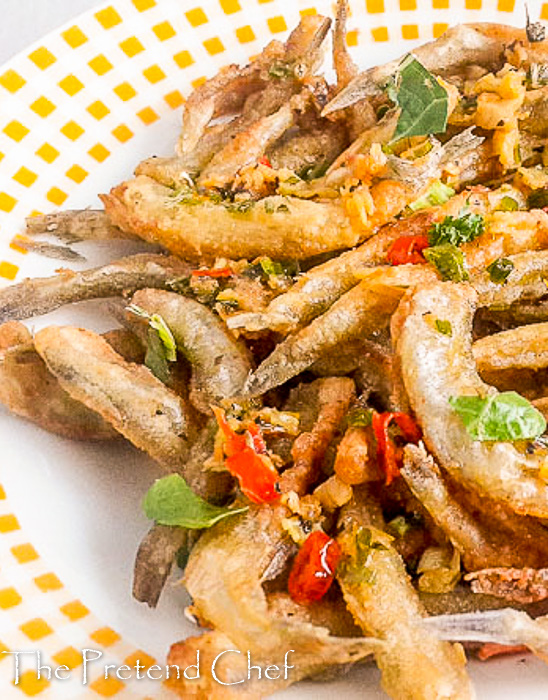 Crunchy, salty and spicy Nigerian crispy fried whitebait fish in Herb butter sauce