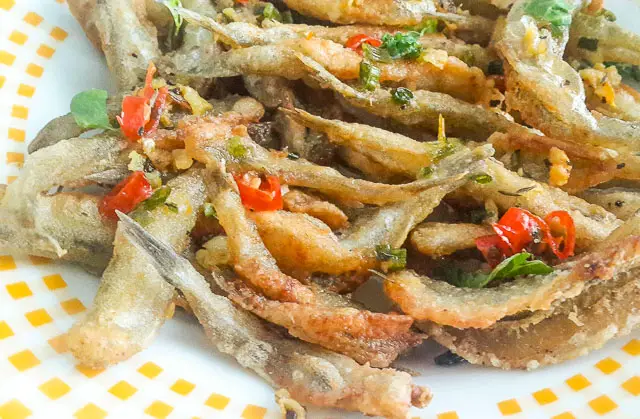 Crunchy, salty and spicy Nigerian crispy fried whitebait fish in Herb butter sauce
