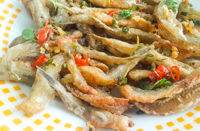 Crunchy, salty and spicy Nigerian crispy fried whitebait fish in Herb butter sauce