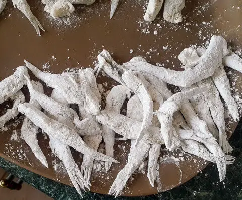 white bait drenched in flour for Nigerian crispy fried whitebait fish
