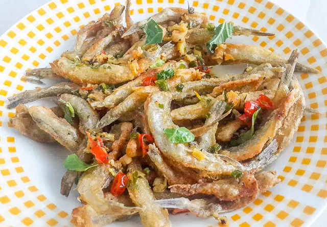 Crunchy, salty and spicy Nigerian crispy fried whitebait fish in Herb butter sauce