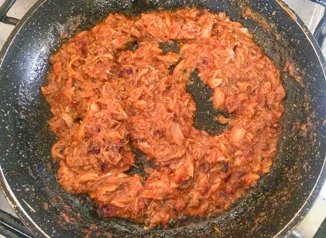 mackerel with onions and pepper frying in frying pan