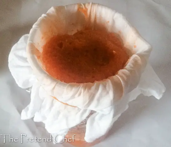 carrot orange juice being sieved