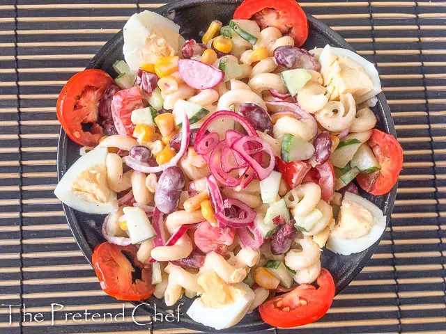 pasta salad, macaroni salad in a bowl with tomatoes and boiled egg
