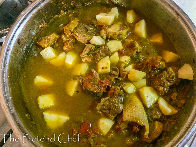 simple coconut curry sauce, showingpotato cubes, bubbling away on the stove top