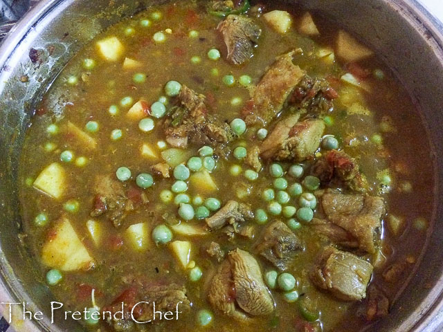 simple coconut curry sauce, showing peas, bubbling away on the stove top