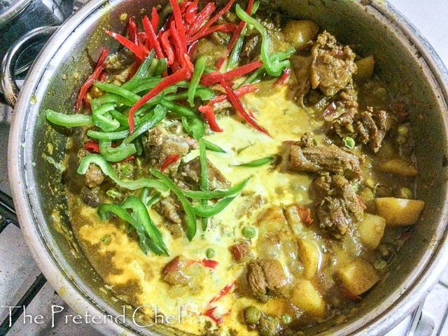 simple coconut curry sauce, showing bell pepper strips, bubbling away on the stove top