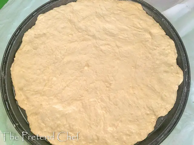 pizza dough on baking tray for How to make homemade pizza
