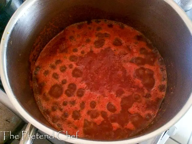 fresh tomato added to pot of fresh tomato sauce