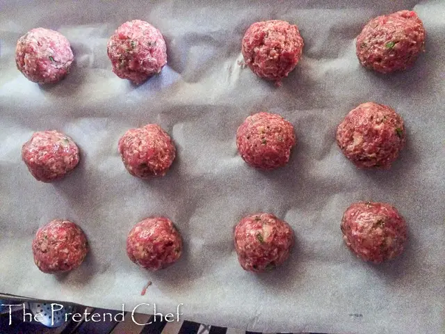 raw meatballs on baking tray