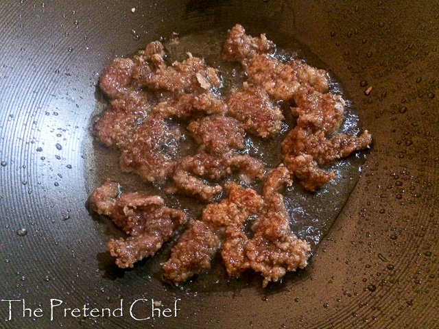 shredded beef frying for mongolian beef stir fry