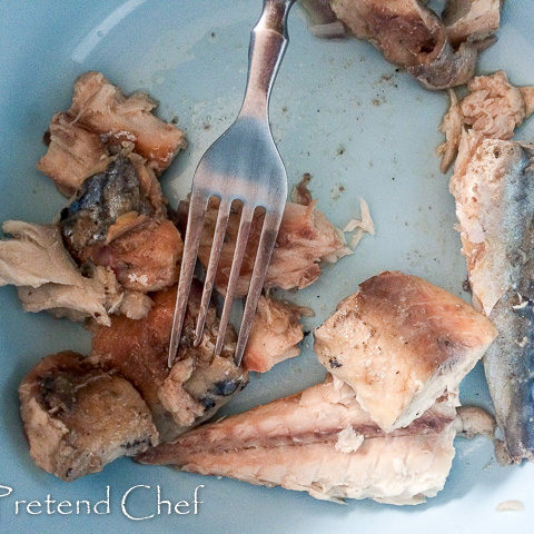 Boiled fish being crushed for Nigerian fish pie