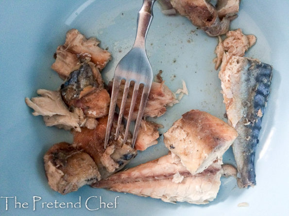 Boiled fish being crushed for Nigerian fish pie