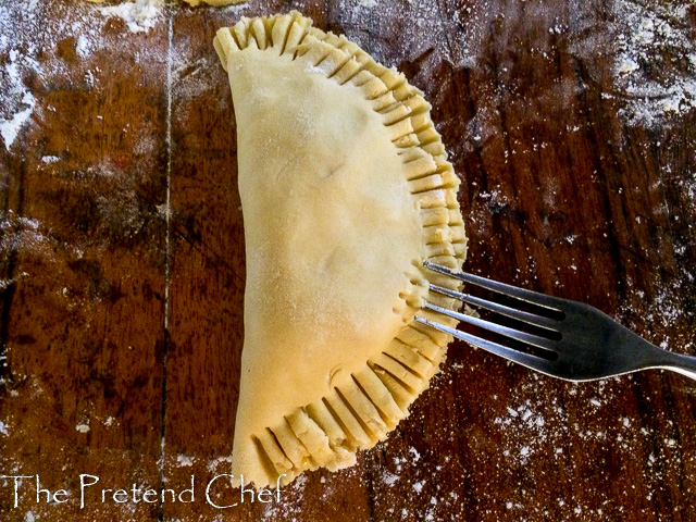 raw Nigerian meat pie being crimped