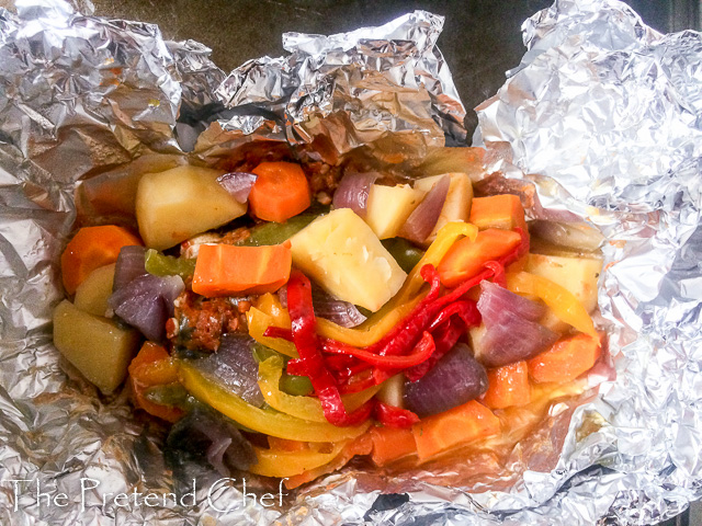 Foil baked fish with vegetables out of the oven