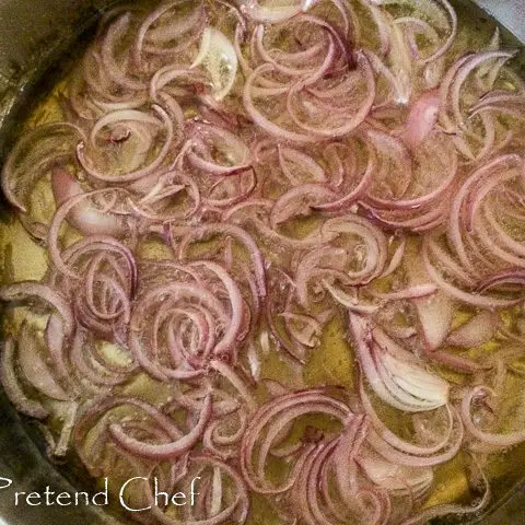onions frying in oil for easy spanish omelette