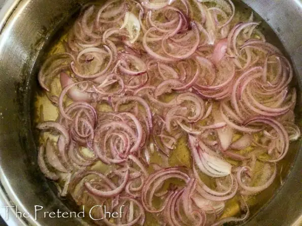 onions frying in oil for easy spanish omelette