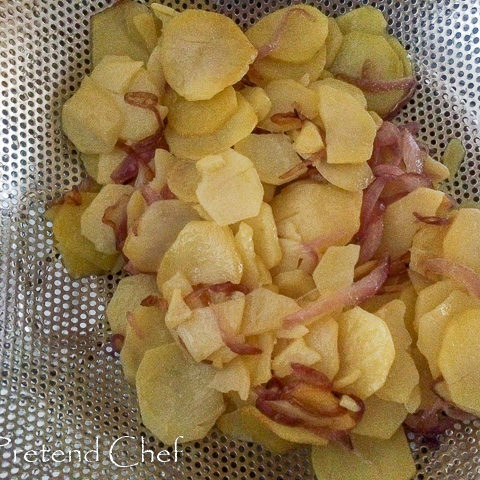 drained softened potatoes and onions draining sieve for easy spanish omelette