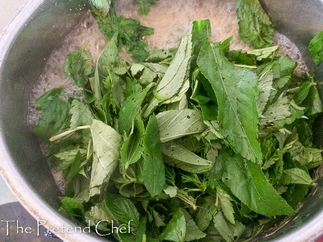 Ewedu (jute) leaves boiling in a pot for Ewedu Soup