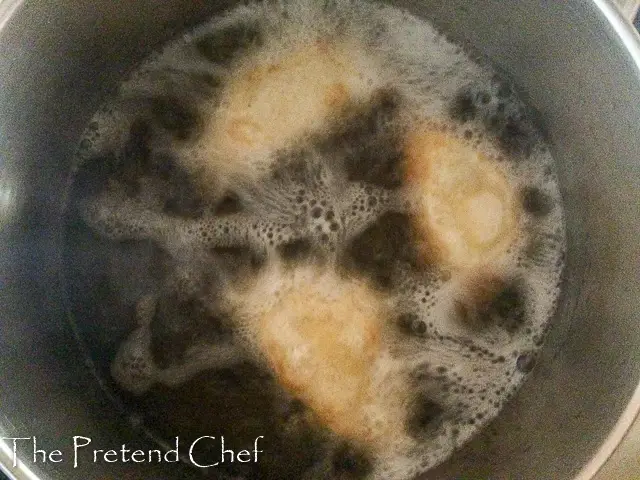 Empanadas frying in hot oil
