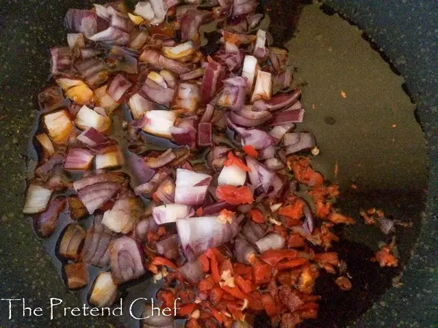 onions and pepper frying in palm oil
