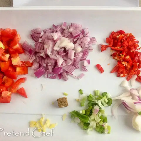 chopped vegetables in a tray for smoked fish with greens