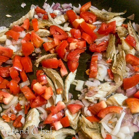 smoked fish with greens frying in a saucepan