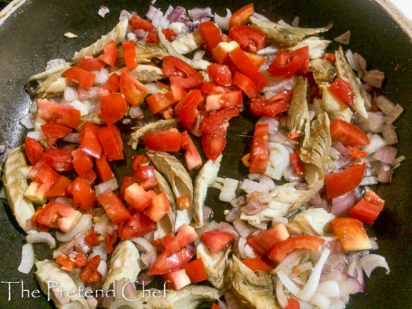 smoked fish with greens frying in a saucepan