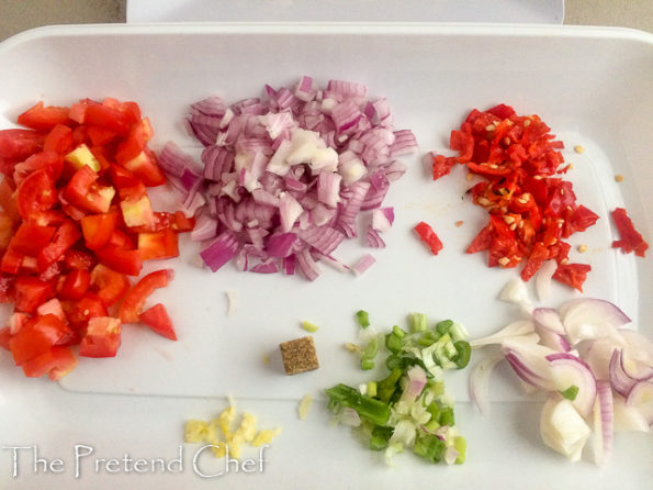 chopped vegetables in a tray for smoked fish with greens