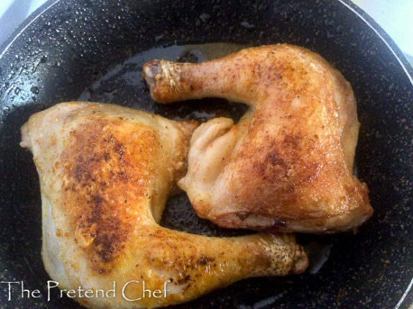 chicken legs frying in pan