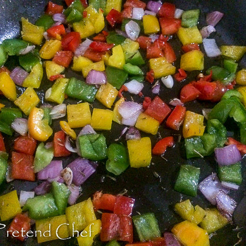 peppers and onions frying in a pan for Couscous with bell peppers