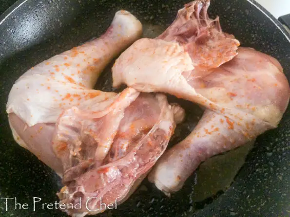 chicken legs frying in pan
