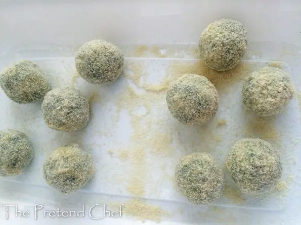 uncooked potato green vegetable balls coated in breadcrumbs and flour