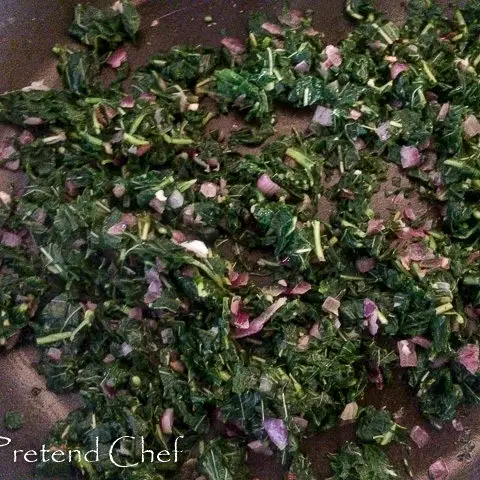 onions and greens in a frying pan