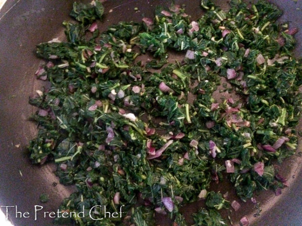 onions and greens in a frying pan